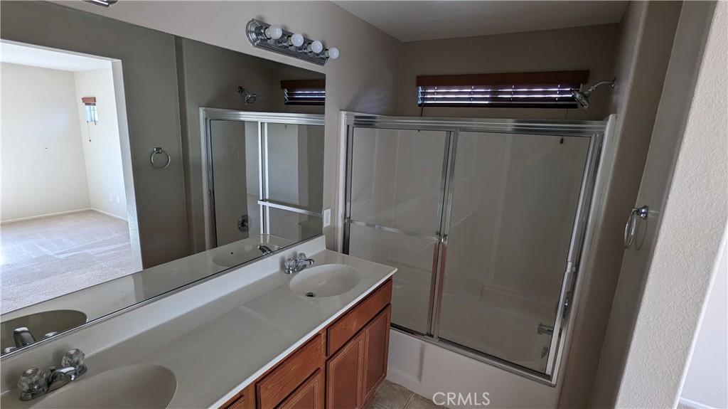 25862 Iris Avenue, Unit B Moreno Valley, CA 92551 - Photo 16 of 23 a bathroom with a sink and a mirror