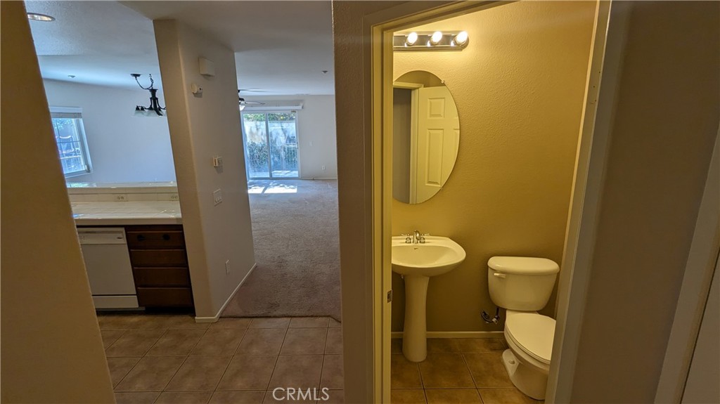 25862 Iris Avenue, Unit B Moreno Valley, CA 92551 - Photo 19 of 23 a bathroom with a toilet mirror and vanity