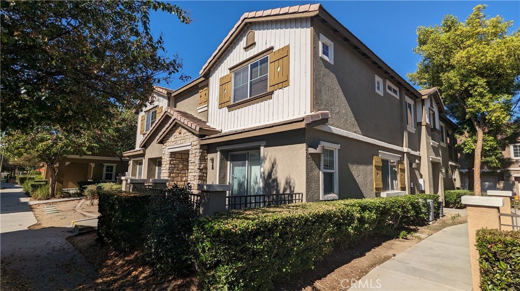25862 Iris Avenue, Unit B Moreno Valley, CA 92551 - Photo 2 of 23 a front view of a house with a yard