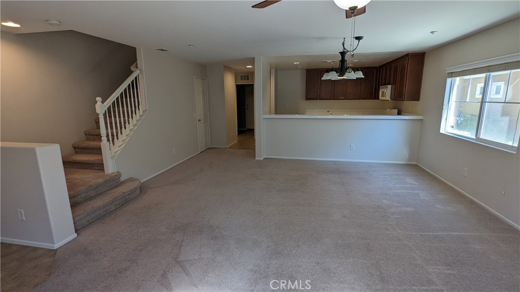 25862 Iris Avenue, Unit B Moreno Valley, CA 92551 - Photo 8 of 23 a view of a kitchen with a sink cabinet and a living room