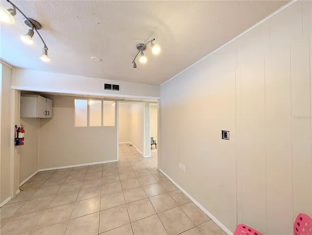 an empty room with closet and windows