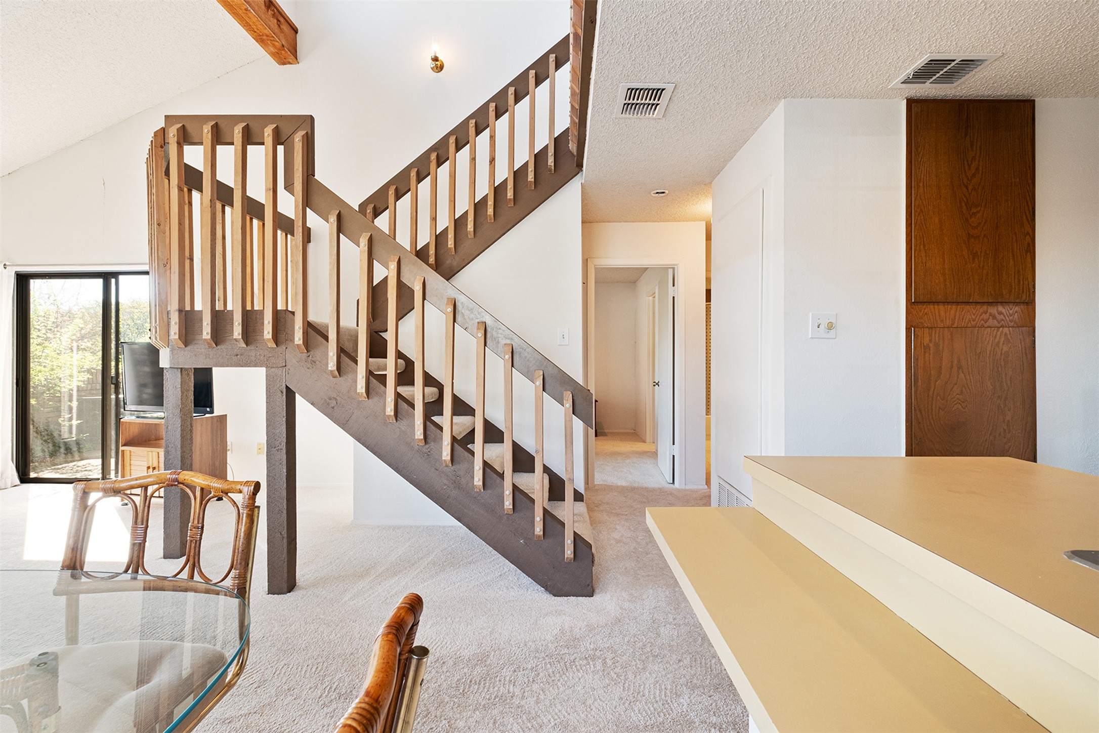 1748 Ohlen Road, Unit 16 Austin, TX 78757 - Photo 12 of 38 Staircase featuring a textured ceiling, carpet flooring, and beamed ceiling