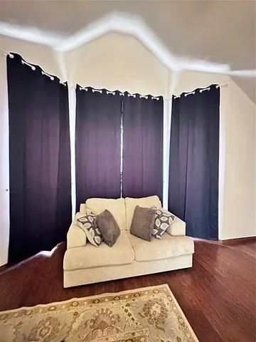 a white bed sitting in a bedroom next to a wooden cabinet