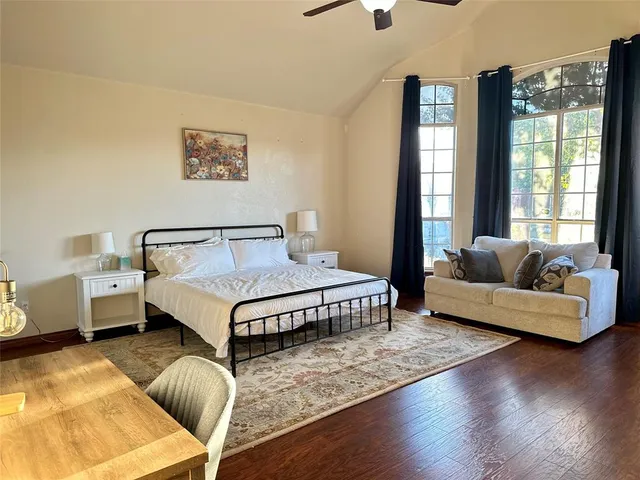 a bedroom with a bed couch and window