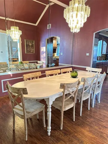 a dining room with furniture a chandelier and wooden floor