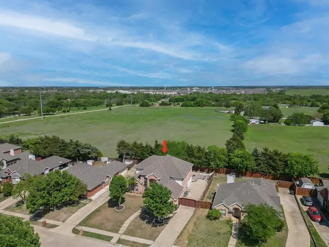 an aerial view of a houses with outdoor space