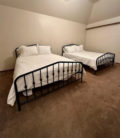 a bedroom with two beds and a window