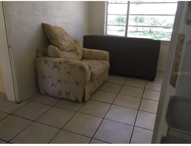 a living room with furniture and a window