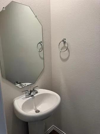 a bathroom with a sink and mirror