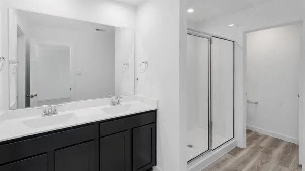 a bathroom with a double vanity sink and mirror