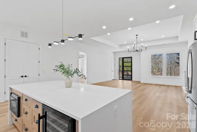 a view of an entryway and kitchen chandelier