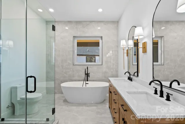 a bathroom with double vanity sinks double vanity tub and shower