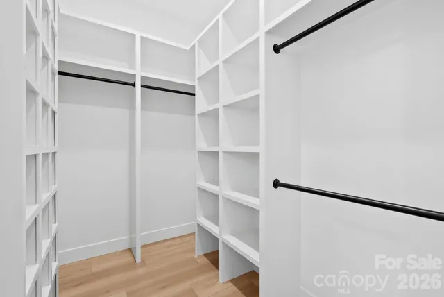 a view of walk in closet with empty racks