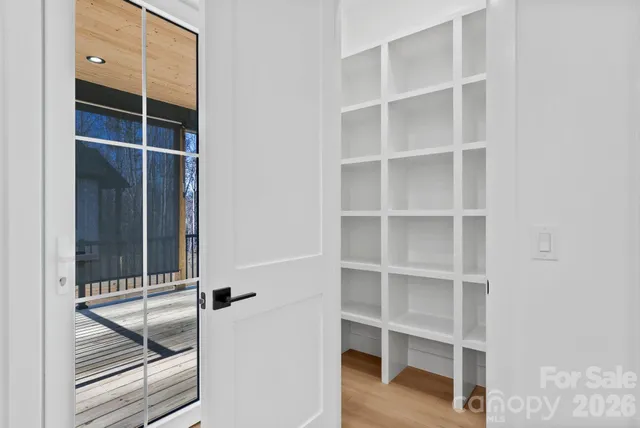 a view of a room with wooden floor and closet