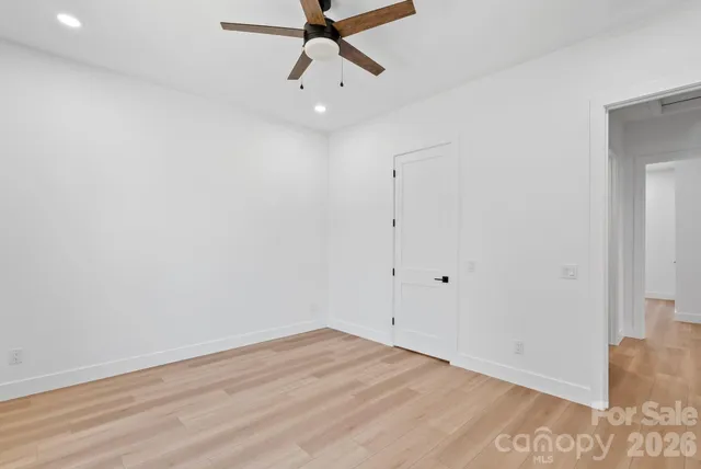 a view of a room with wooden floor