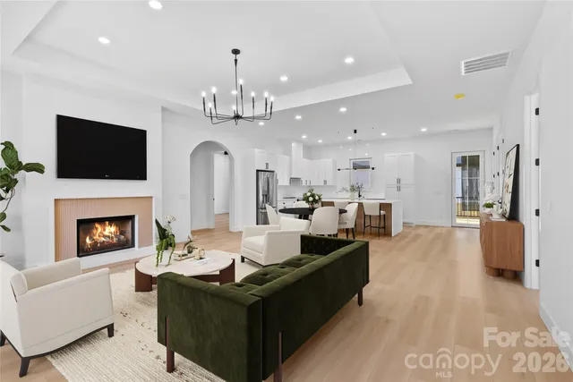 a living room with furniture fireplace and flat screen tv
