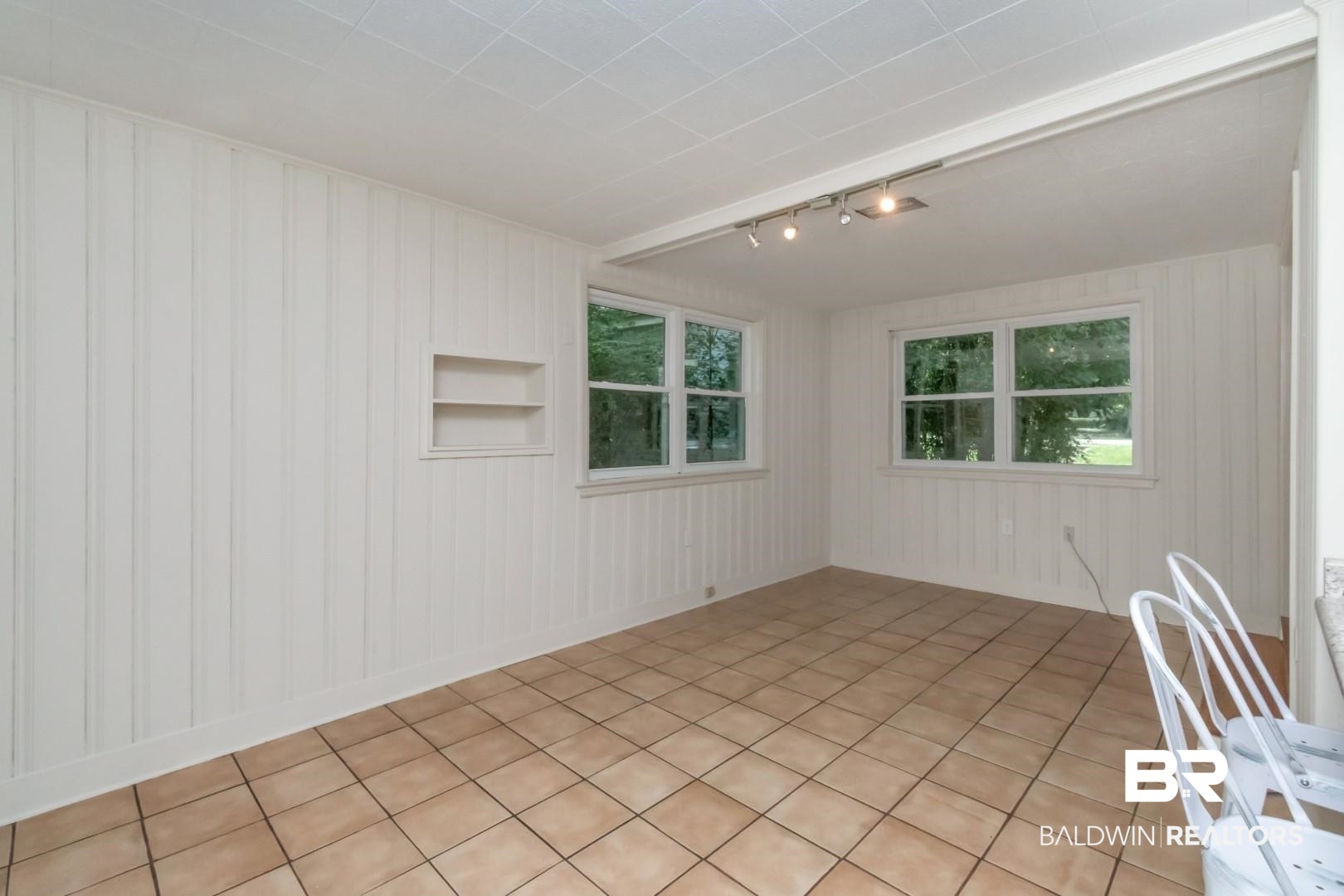 1906 Old Shell Road Mobile, AL 36607 - Photo 17 of 26 Spare room with light tile patterned flooring, a healthy amount of sunlight, built in shelves, and rail lighting