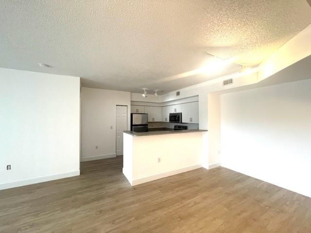 7930 North Nob Hill Road, Unit 106 Tamarac, FL 33321 - Photo 8 of 12 a view of a kitchen with a sink and a refrigerator