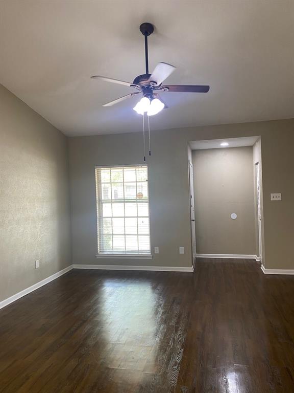 13652 Flagstone Lane Dallas, TX 75240 - Photo 7 of 15 Unfurnished room with dark wood finished floors and a ceiling fan