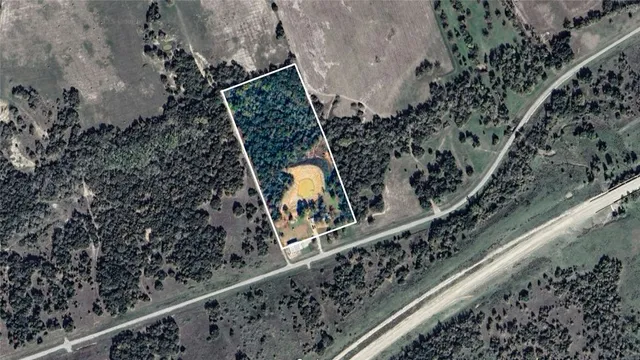 an aerial view of a house with yard swimming pool and outdoor seating