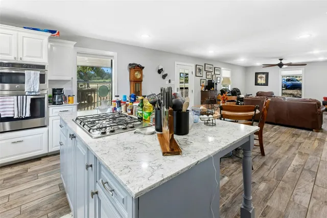 a kitchen with stainless steel appliances granite countertop a stove and a refrigerator