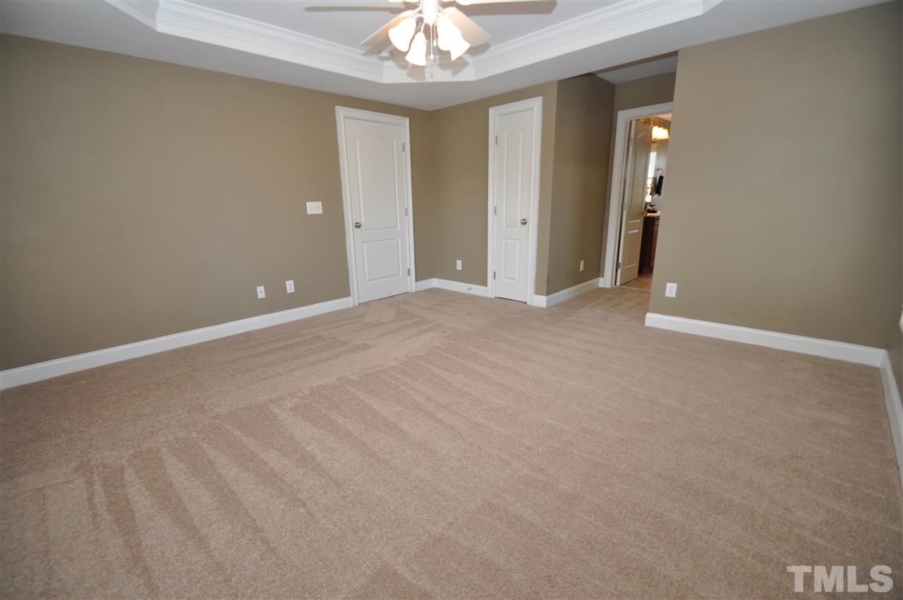 165 Fort Jackson Road Morrisville, NC 27560 - Photo 15 of 25 a view of an empty room with a chandelier fan