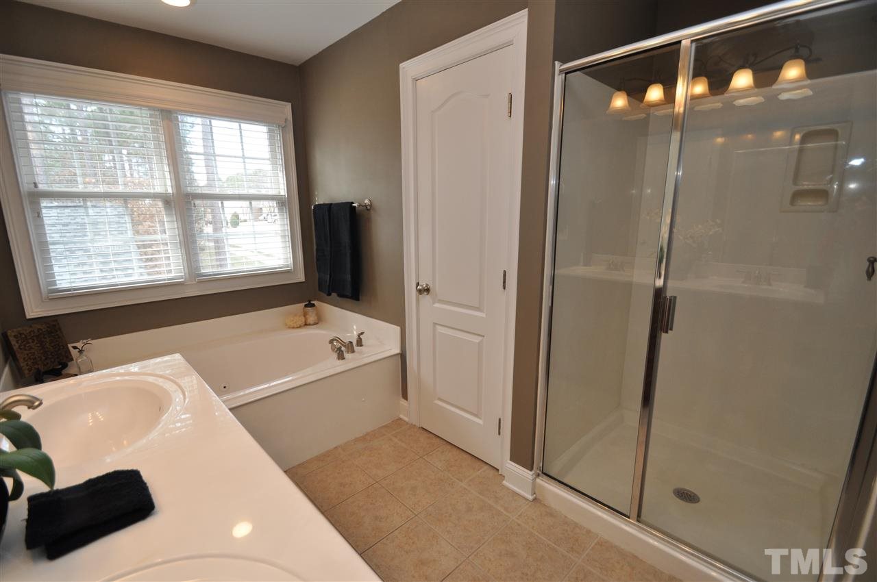 165 Fort Jackson Road Morrisville, NC 27560 - Photo 17 of 25 a bathroom with a bathtub and a shower