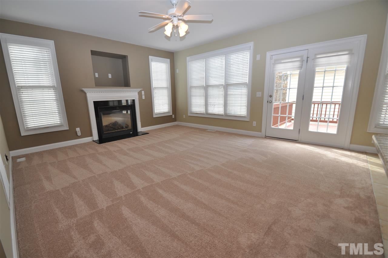 165 Fort Jackson Road Morrisville, NC 27560 - Photo 5 of 25 a view of an empty room with a window and fireplace
