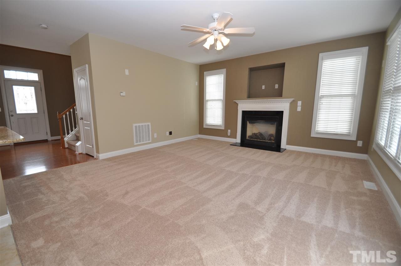 165 Fort Jackson Road Morrisville, NC 27560 - Photo 6 of 25 a view of an empty room with a fireplace and a window
