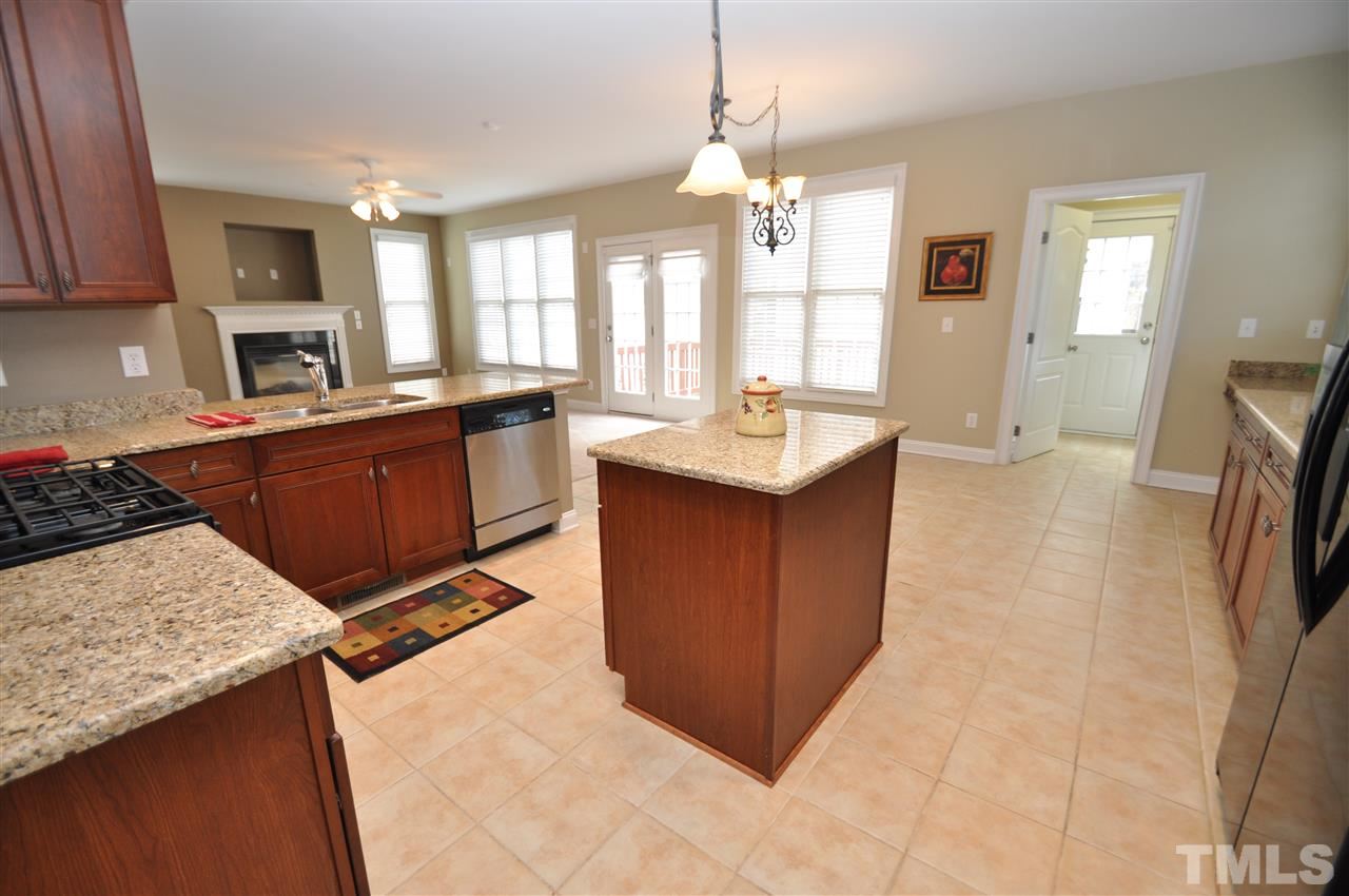 165 Fort Jackson Road Morrisville, NC 27560 - Photo 10 of 25 a kitchen with stainless steel appliances granite countertop a sink stove and refrigerator