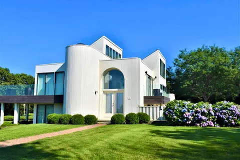 a front view of a house with a garden