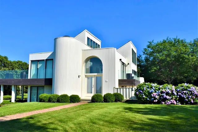 a front view of a house with a garden