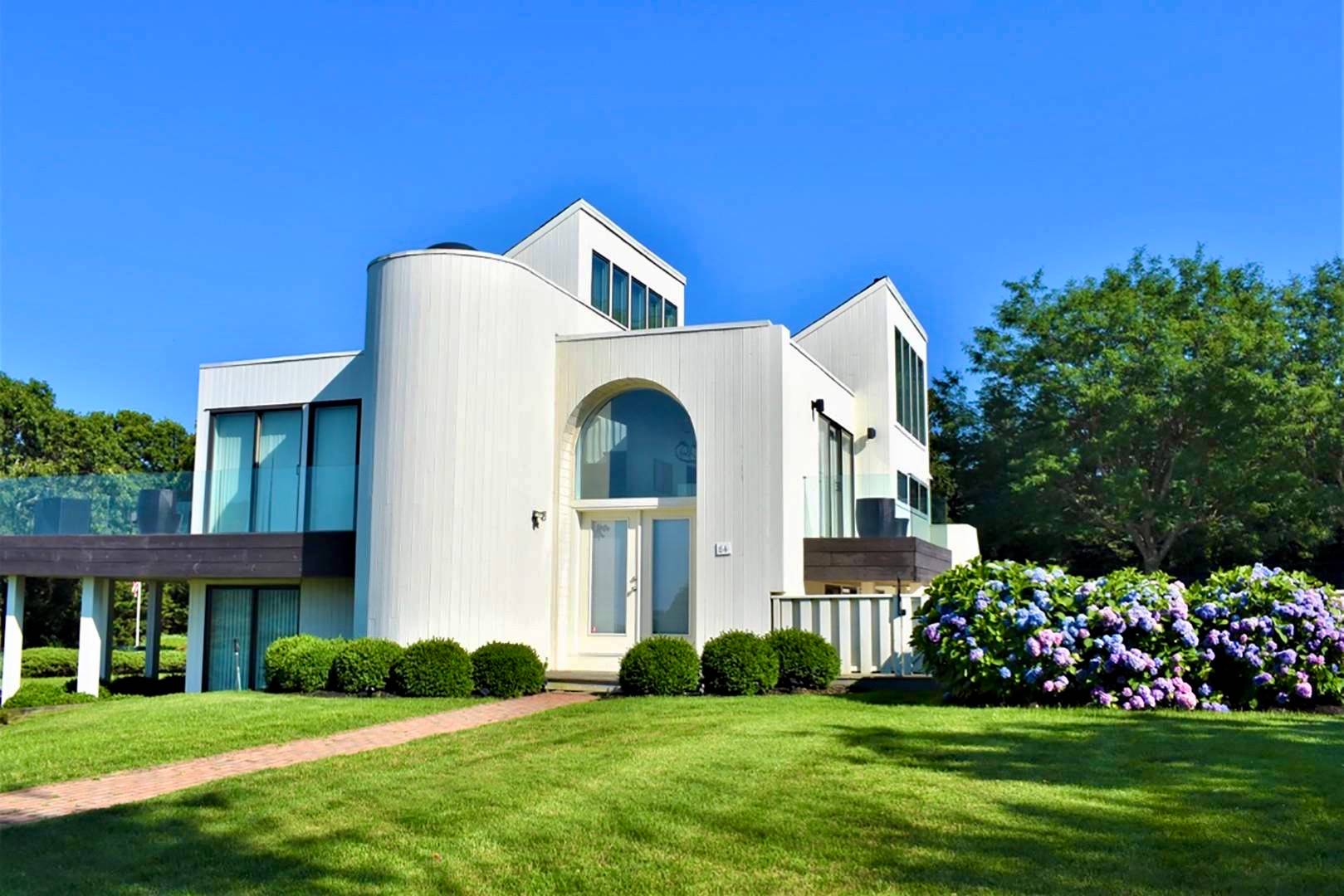 a front view of a house with a garden