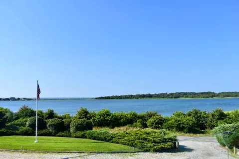 a view of a lake with a house in background