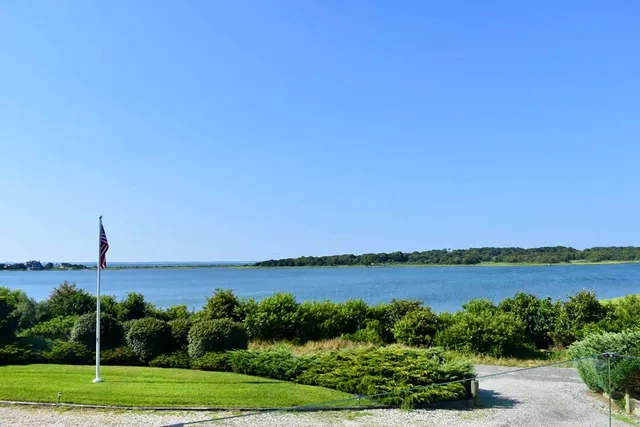 a view of a lake with a house in background