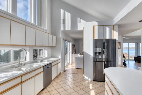 a kitchen with stainless steel appliances granite countertop a refrigerator sink and cabinets