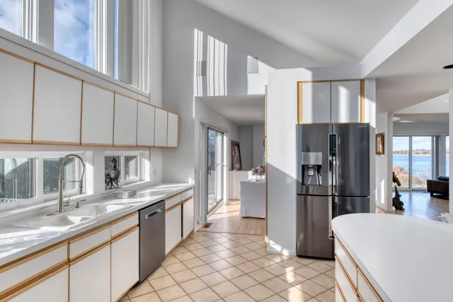 a kitchen with stainless steel appliances granite countertop a refrigerator sink and cabinets