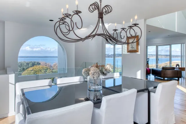a living room with furniture a chandelier and a large window