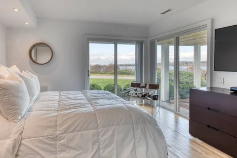 a bedroom with a large bed and a large window