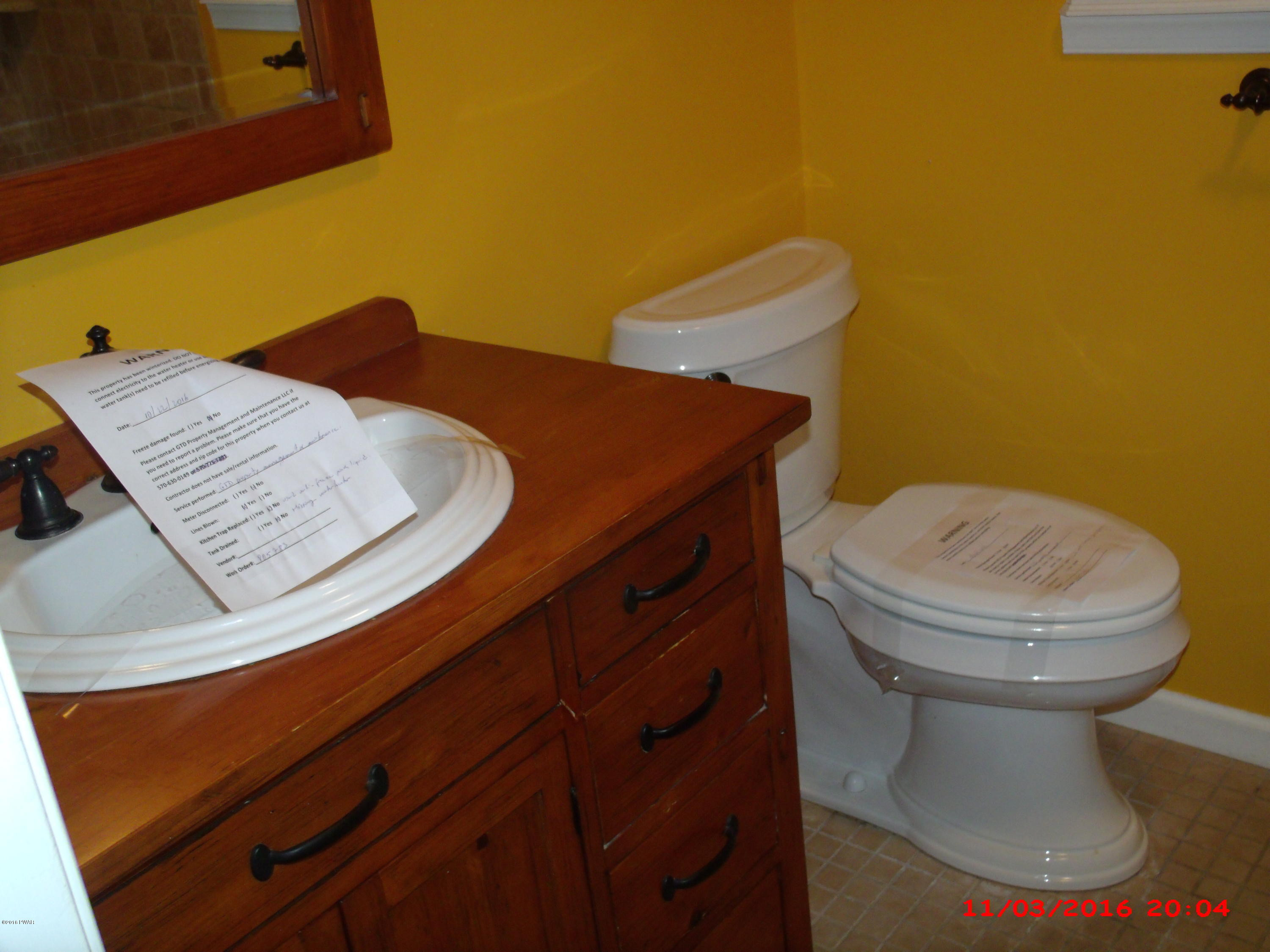 397 Perkins Pond Road Beach Lake, PA 18405 - Photo 12 of 25 a bathroom with a sink and a toilet