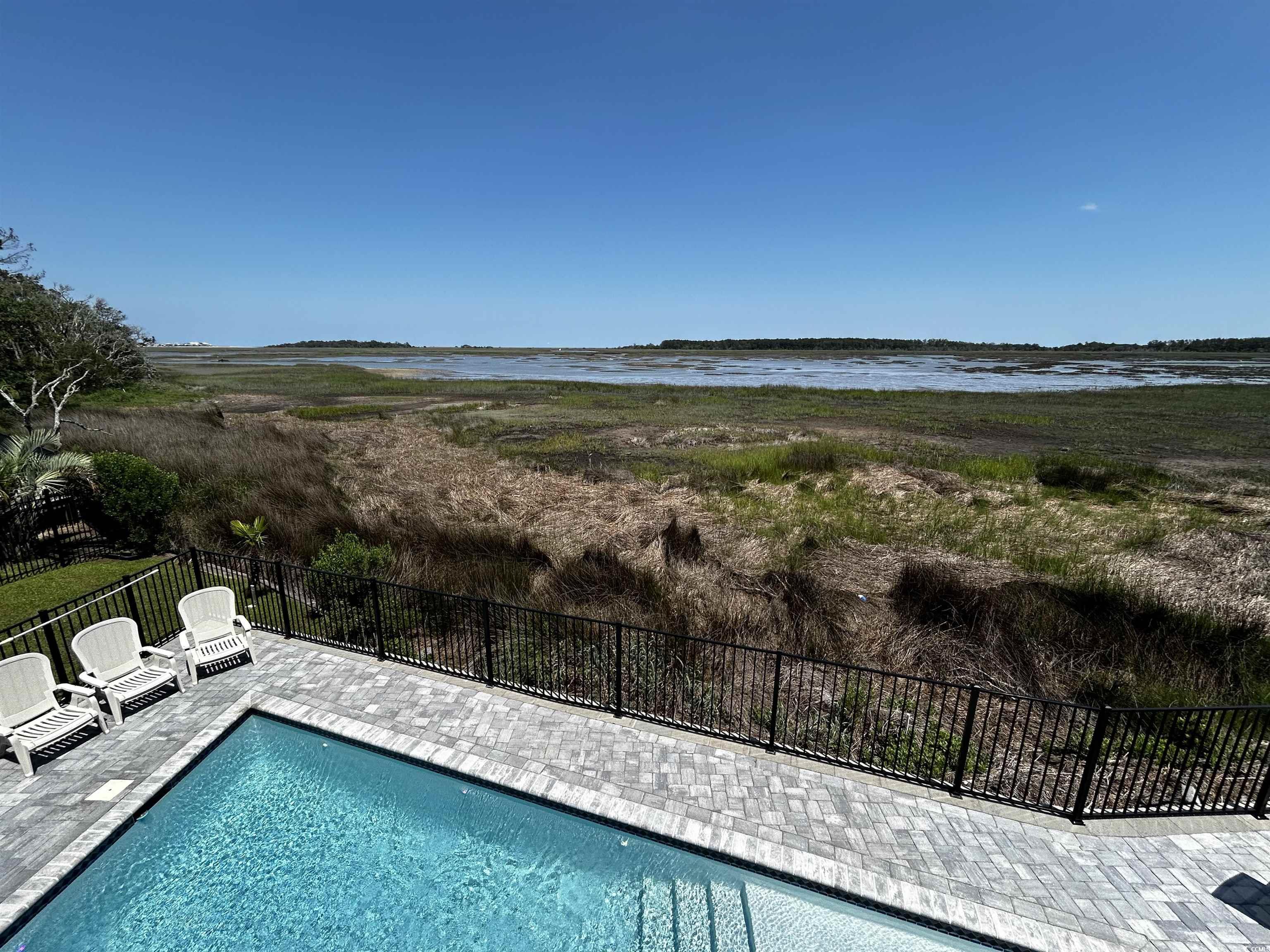 88 Gillette Place Murrells Inlet, SC 29576 - Photo 37 of 40 View of swimming pool featuring a patio area, a wa