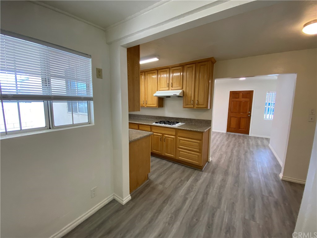 2554 Potrero Avenue El Monte, CA 91733 - Photo 11 of 22 a kitchen with kitchen island wooden floors and stainless steel appliances