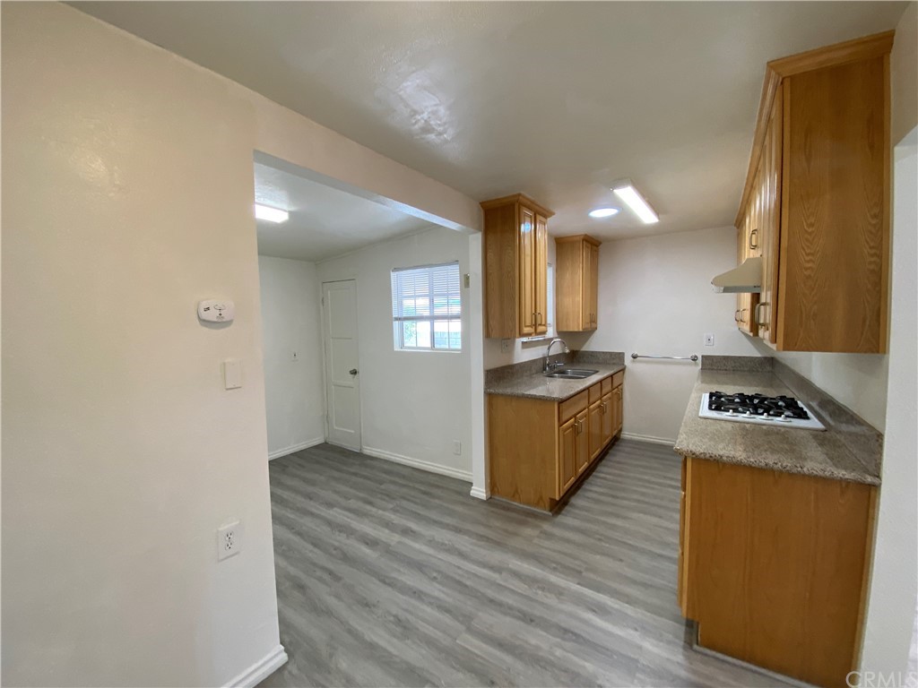 2554 Potrero Avenue El Monte, CA 91733 - Photo 8 of 22 a kitchen with granite countertop a stove top oven and cabinets