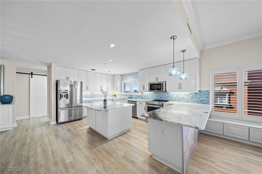 14813 Laguna Drive, Unit 301 Fort Myers, FL 33908 - Photo 12 of 50 a kitchen with refrigerator and wooden floor