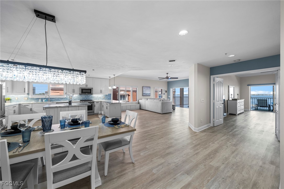 14813 Laguna Drive, Unit 301 Fort Myers, FL 33908 - Photo 14 of 50 a kitchen with stainless steel appliances granite countertop a kitchen island a stove and a cabinets