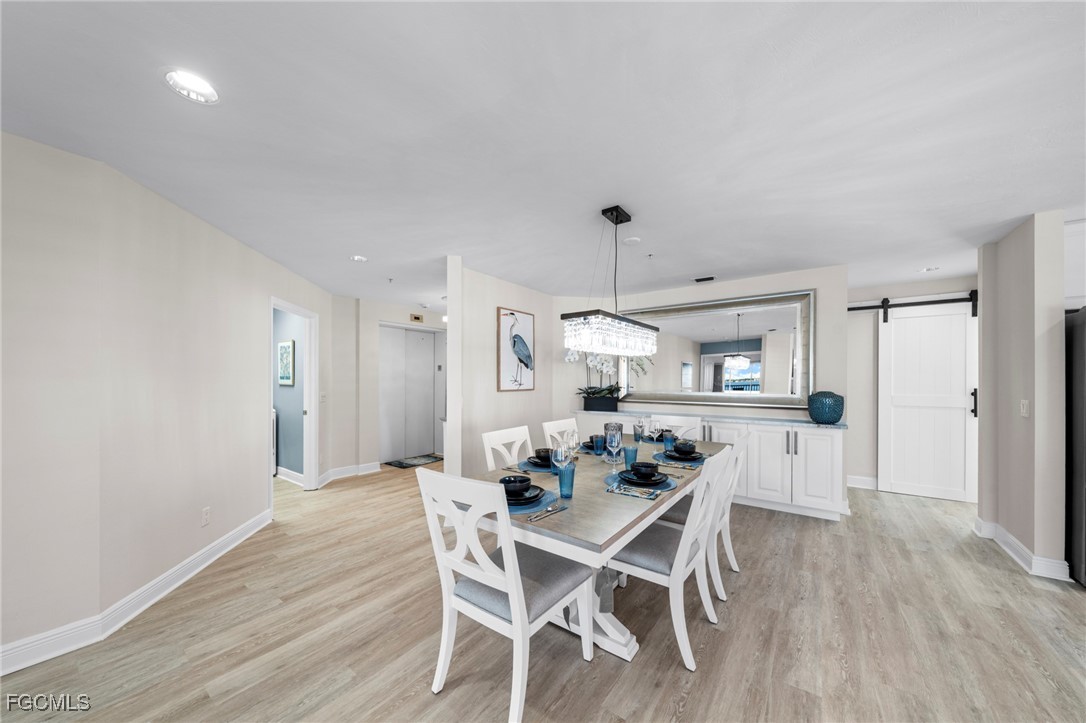 14813 Laguna Drive, Unit 301 Fort Myers, FL 33908 - Photo 15 of 50 a view of a dining room with furniture and wooden floor