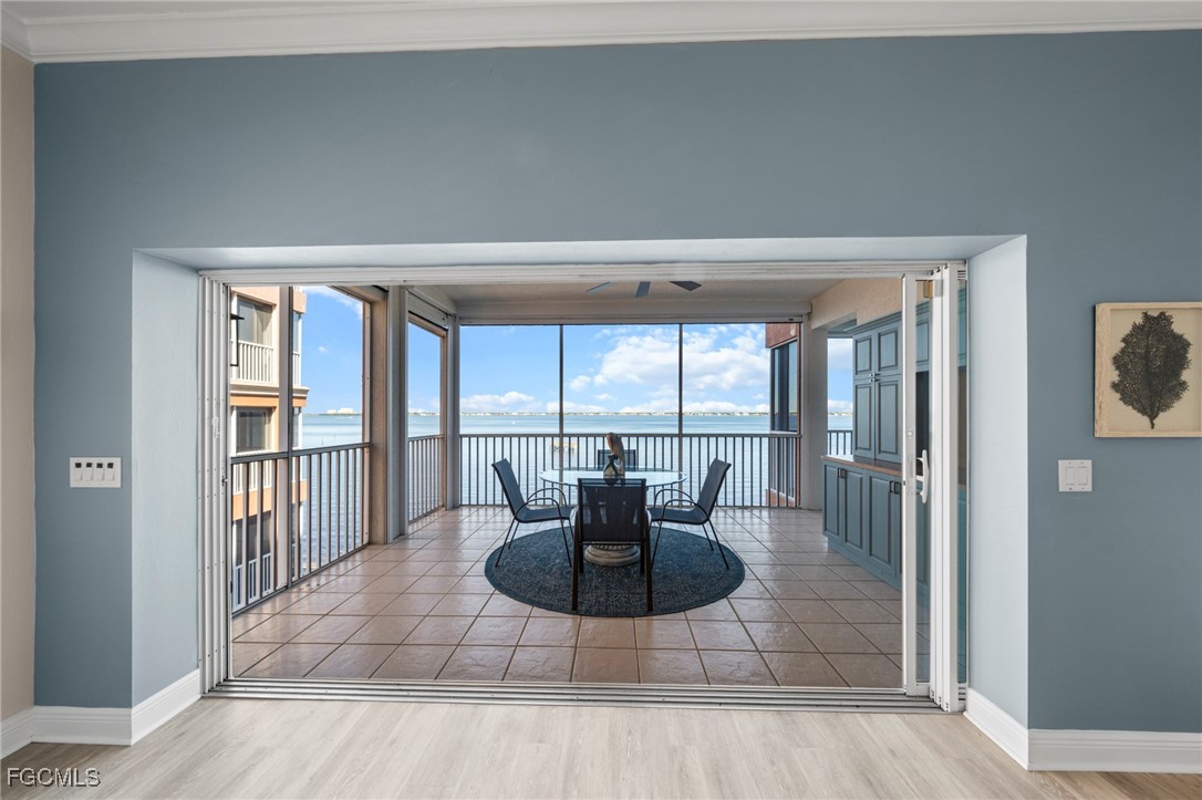 14813 Laguna Drive, Unit 301 Fort Myers, FL 33908 - Photo 17 of 50 a living room with furniture and a floor to ceiling window