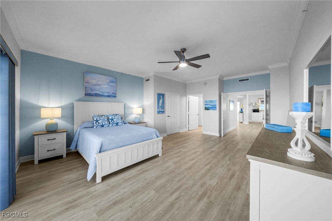 14813 Laguna Drive, Unit 301 Fort Myers, FL 33908 - Photo 22 of 50 a bedroom with a bed and a chandelier