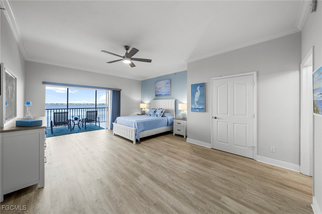 14813 Laguna Drive, Unit 301 Fort Myers, FL 33908 - Photo 23 of 50 a spacious bedroom with a bed and large windows