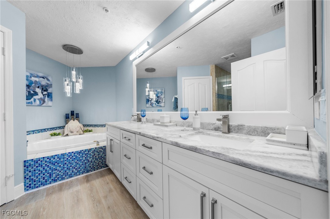 14813 Laguna Drive, Unit 301 Fort Myers, FL 33908 - Photo 24 of 50 a spacious bathroom with double sink and a large mirror